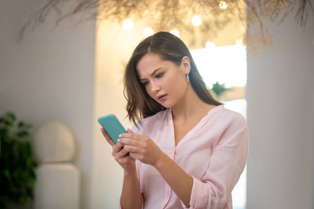 istock Serious thoughtful woman looking at the smartphone screen 1194330182