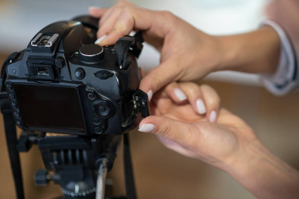 istock Close up of female hands setting up the camera 1194330183