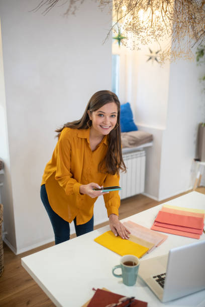 istock Positive cheerful woman taking photos of samples 1194330186