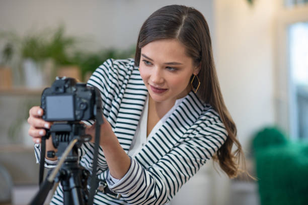 istock Beautiful young woman setting up the camera 1194330187