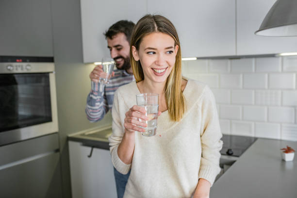 Couple at home drinking water