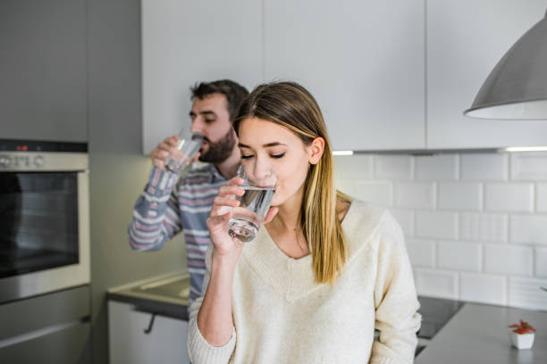 istock Couple at home drinking water 1194331167