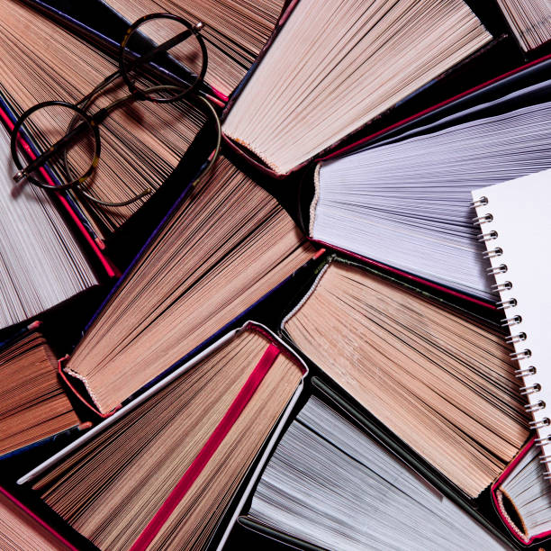 istock Library. Old open books stand on a bookshelf ready to read. Close-up 1194331420