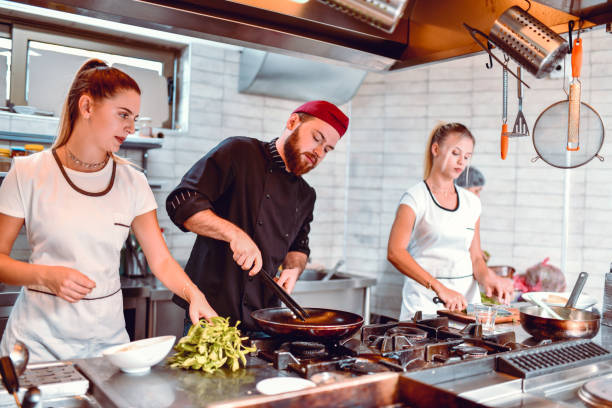 istock Kitchen Team Working Together To Make The Best Food 1194331455
