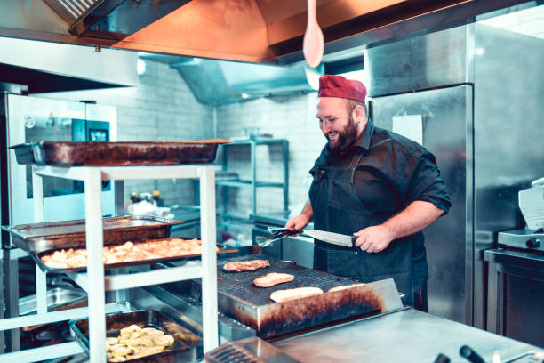 istock Happy Male Cook Preparing Meat And Bread On Barbecue 1194331581