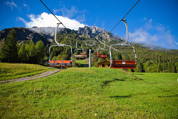 Chair lift in Alps mountain view stock photo