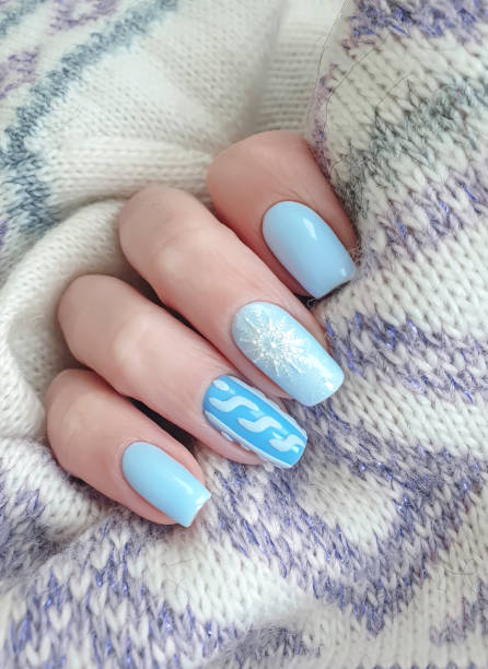 istock female hand beautiful manicure sweater 1194335853