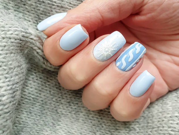 istock female hand beautiful manicure sweater 1194336080