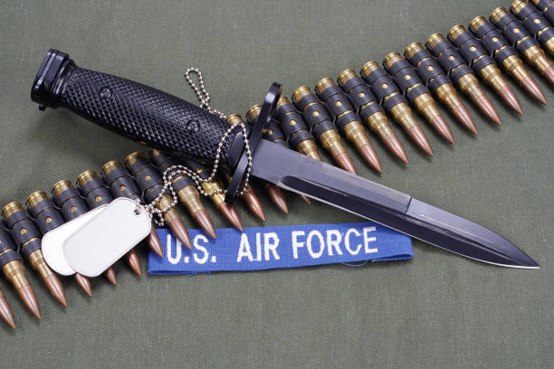 bayonet and ammunition belt with dog tags on US AIR FORCE uniform background