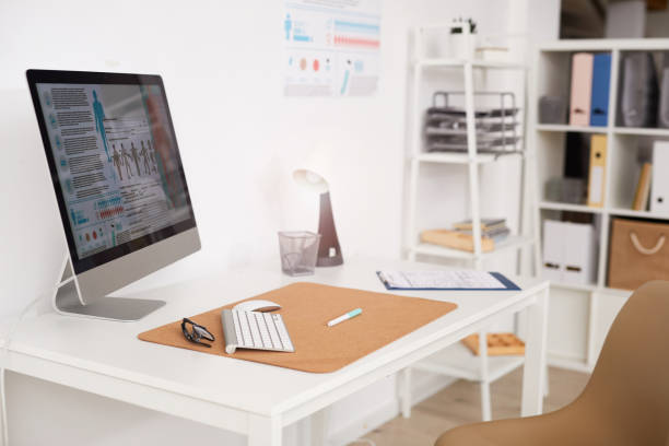 istock Medical schemes and article on computer screen placed on table with clipboard in doctors office 1194338367