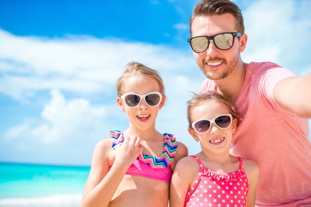 istock Father and kids enjoying beach summer vacation 1194339397