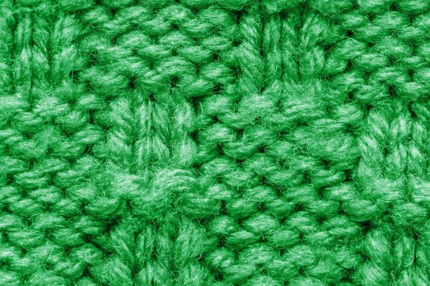 istock The texture of a knitted sweater. Green pattern. 1194339448