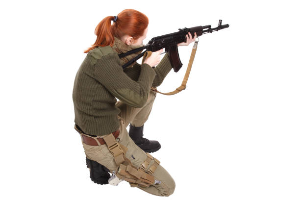istock girl mercenary with ak-47 rifle 1194342387