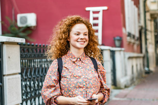 istock Young woman using smart phone on the street 1194343553