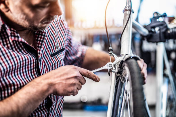 istock Mechanic repairing bicycle brakes. 1194343908