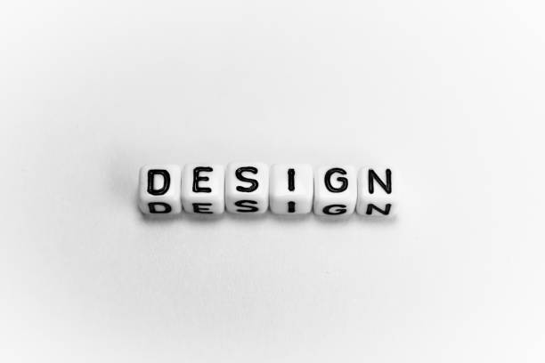 istock White cubes with word DESIGN on white paper background and dark shadows 1194344550