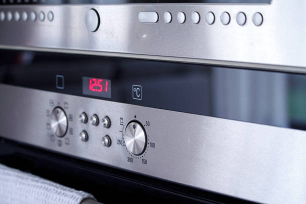 istock Close-up the front panel of the oven with control poles and switching baking modes, selective focus 1194345019