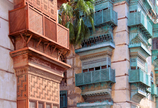 Al Balad district - red and green rawasheen / mashrabiya balconies - hedjazi architecture - Historic Jeddah, Saudi Arabia - UNESCO world heritage site Jeddah, Mecca Region, Saudi Arabia: of hedjazi architecture in Al Balad district, Nadalah Ibn Khalid Lane - building with Arabian closed balconies (rawasheen / mashrabiyas), Historic Jeddah, the Gate to Makkah, UNESCO world heritage site. Red Sea coastal coral building tradition. jeddah stock pictures, royalty-free photos & images