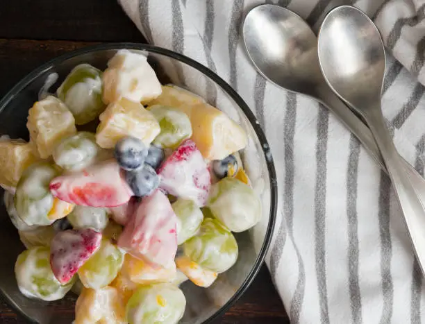 A healthier version of classic ambrosia fruit salad made with various fruit and vanilla-yogurt dressing