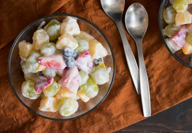 A healthier version of classic ambrosia fruit salad made with various fruit and vanilla-yogurt dressing