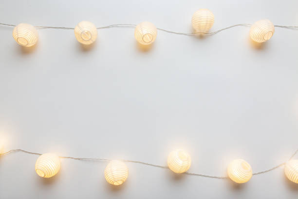 istock Shining electric garland on white empty background border frame 1194351418