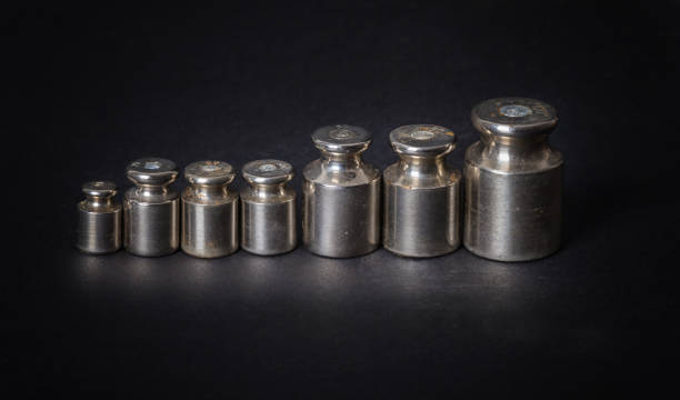 istock a set of small metal weights on a gray background 1194355514