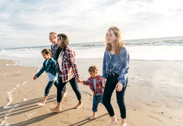 istock Family walking on the beach 1194372148