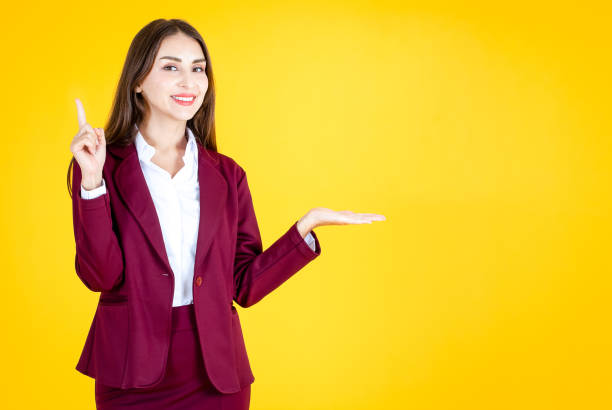 istock Women present products on a yellow background.Copy space 1194372485