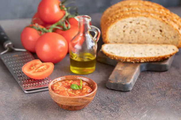 Photo of Crusty bread with fresh tomato or pan con tomate in Spanish, popular tapa  in Spain.