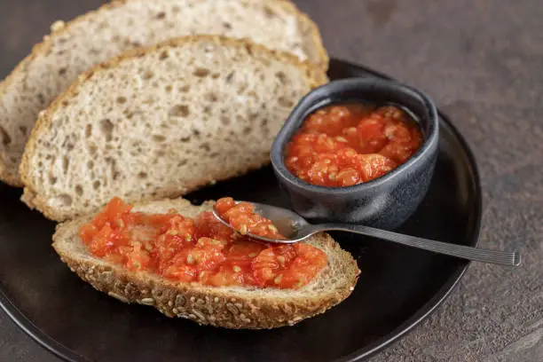 Photo of a amb tomaquet or tomaca or pan con tomate (bread with tomato) classic snack in Catalan and Spanish cuisine, eaten for breakfast.