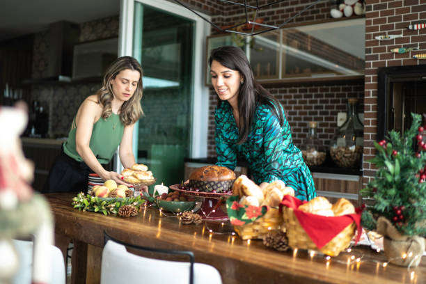 Woman friends setting the table before christmas celebration