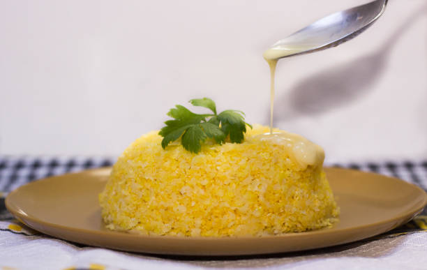 cuscuz - traditional dish from northeastern brazil. cuscuz can be made from flour, corn, rice or cassava. butter being poured into couscous. - baking flour ingredient animal egg imagens e fotografias de stock