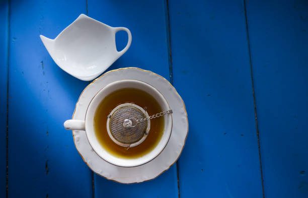 istock Tea cup on a blue wooden table. Warm drink, flat lay with copy space. 1194379611