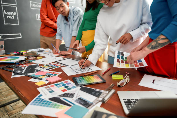 istock Website development concept. Cropped photo of creative people prototyping new web site design for a client while having a meeting in the modern office. Creative agency concept 1194382148