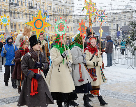 Children carry the traditional Christmas Stars during celebration Christmas in the street of Kyiv.