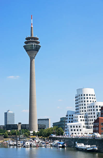 scenic look at the rheinturm tower in dusseldorf - dusseldorf stockfoto's en -beelden