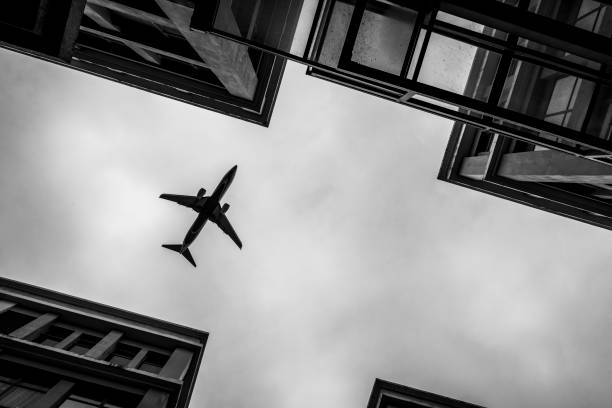 istock Plane flying low over city buildings 1194392017