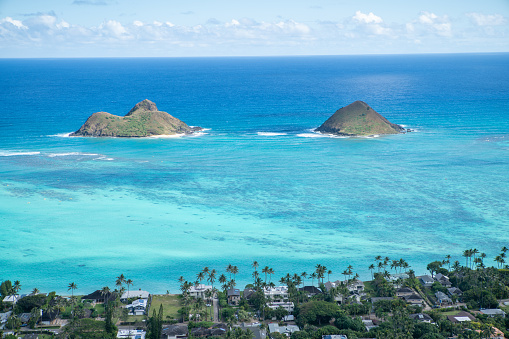 Beautiful view of tropical beach and reef from mountain top. Blue and greens.\nShot in Hawaii, USA
