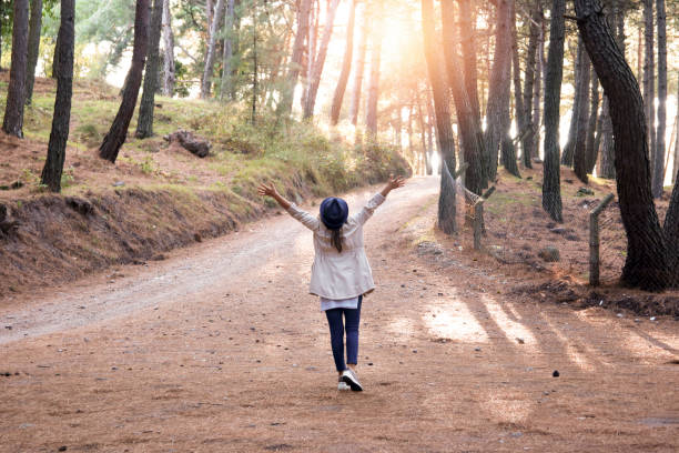 istock Young woman with hat enjoying nature in  forest 1194393231