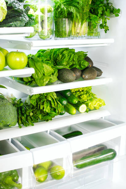 istock Fresh green vegetables and fruits in fridge. 1194393771