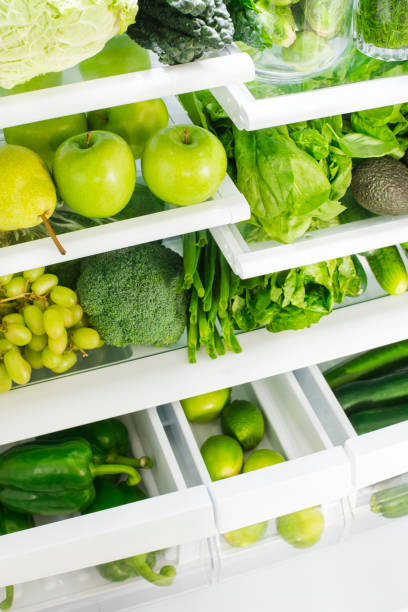 istock Fresh green vegetables and fruits in fridge. 1194393812