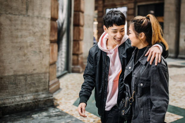istock Happy young couple walking in the rain 1194393814