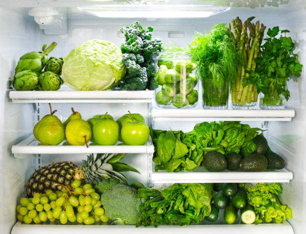istock Fresh green vegetables and fruits in fridge. 1194393829