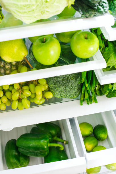 istock Fresh green vegetables and fruits in fridge. 1194393849