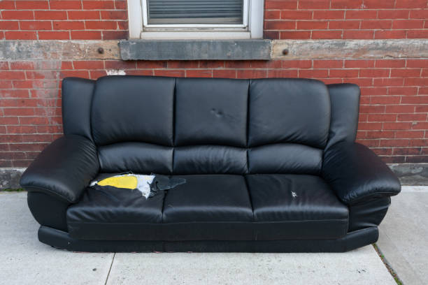 istock Wrecked Couch on a New York Sidewalk left for Garbage 1194395052