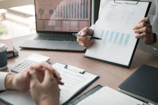 istock Business employee man are reporting about performance graphs summary and financial budget calculations for managers in the office. 1194395054