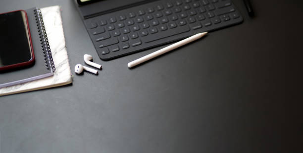 istock Top view of dark modern workplace with office supplies and copy space on black table 1194395870