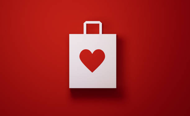 istock White Shopping Bag with Heart Shape on Red Background 1194396002
