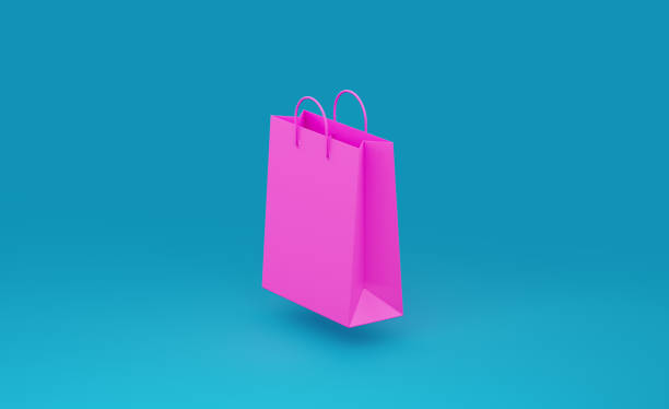 Pink shopping bag  over teal background. Horizontal composition with copy space. Great use for shopping related concepts.