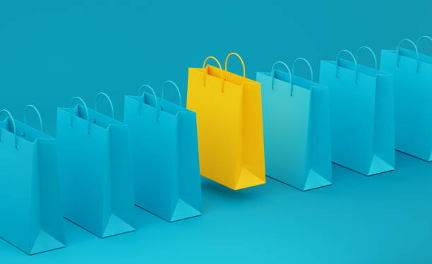 yellow shopping bag standing out from teal shopping bags over teal background - concepts sale ideas retail imagens e fotografias de stock